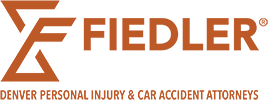 Logo for Fiedler Trial Lawyers with the tagline "Denver Personal Injury & Car Accident Attorneys" in orange text, alongside a stylized "F" design.