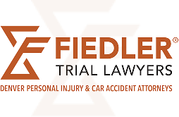 Logo for Fiedler Trial Lawyers with text stating "Denver Personal Injury & Car Accident Attorneys" underneath the firm’s name.